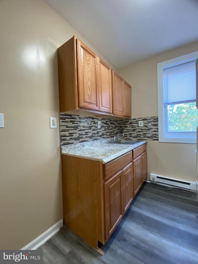 kitchen featuring a baseboard radiator, decorative backsplash, light stone countertops, and dark hardwood / wood-style flooring