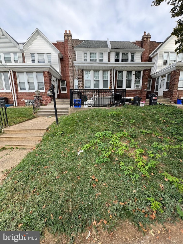 townhome / multi-family property with a front lawn