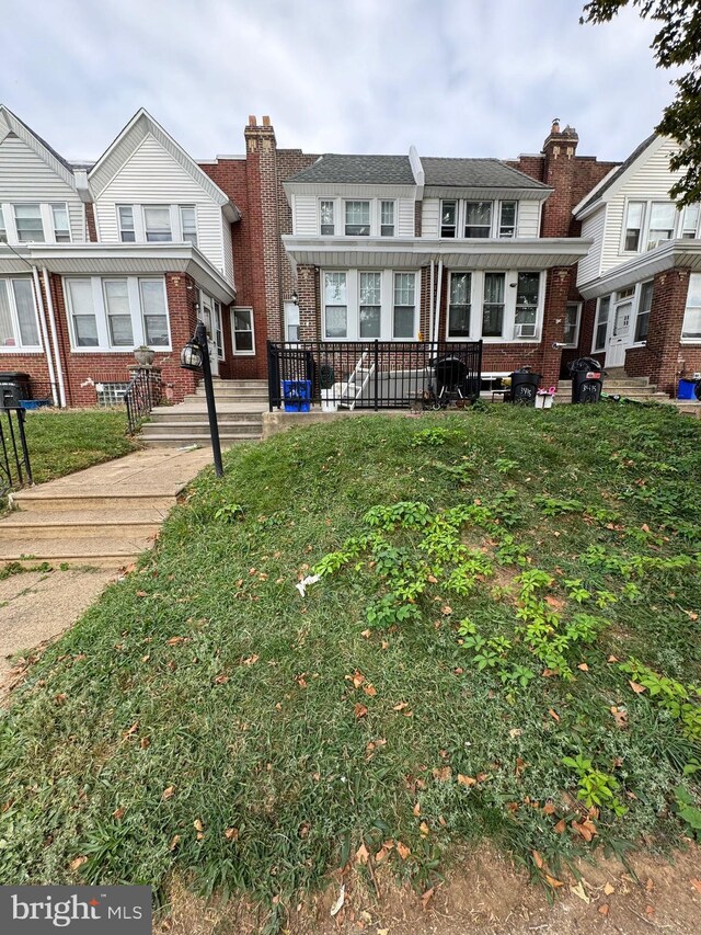 3413 Tudor St, Philadelphia, PA 19136 - rear view of property with brick siding and a lawn