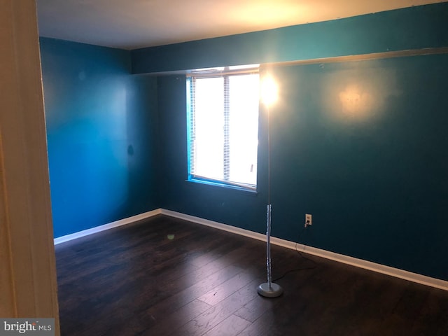 spare room with dark hardwood / wood-style flooring