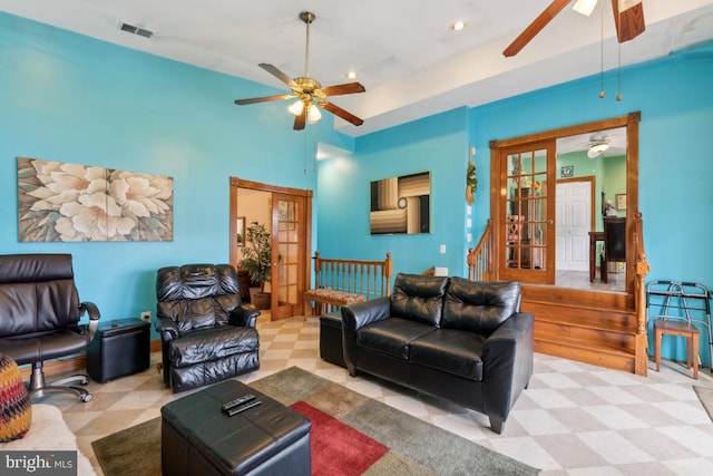 living room featuring ceiling fan and french doors