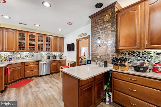 kitchen with hanging light fixtures, light hardwood / wood-style floors, decorative backsplash, kitchen peninsula, and stainless steel dishwasher