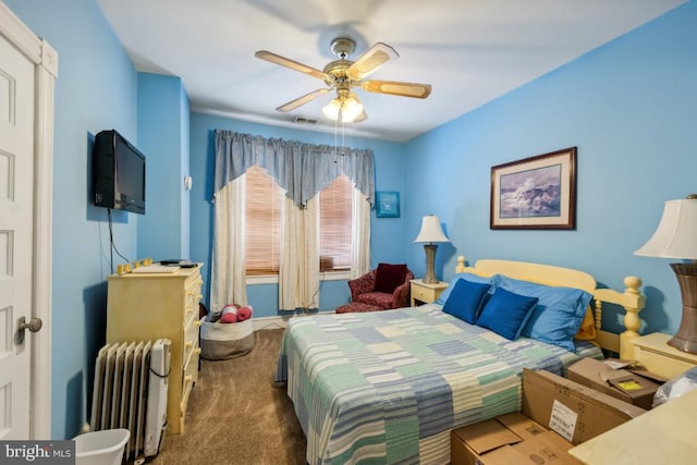 carpeted bedroom featuring ceiling fan and radiator heating unit