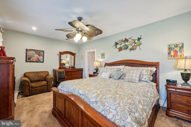 bedroom with ceiling fan and light colored carpet