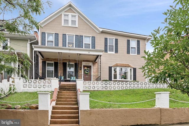 view of front facade with a front lawn and covered porch