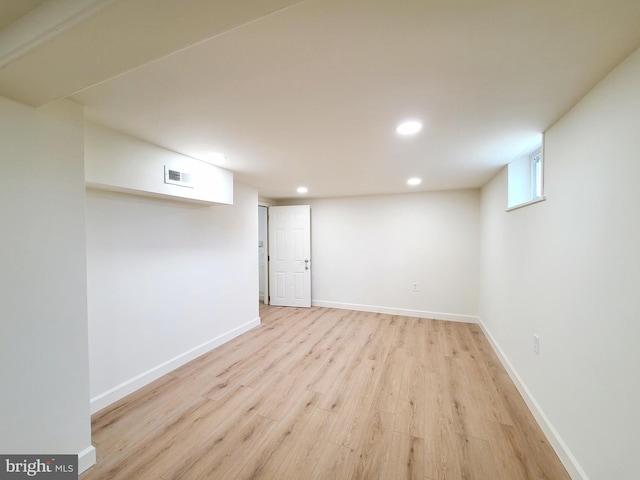 below grade area featuring baseboards, light wood-type flooring, visible vents, and recessed lighting