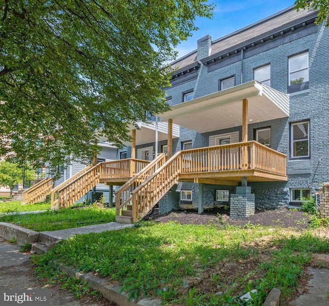 back of property featuring a wooden deck