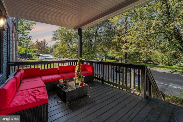 deck at dusk featuring an outdoor hangout area