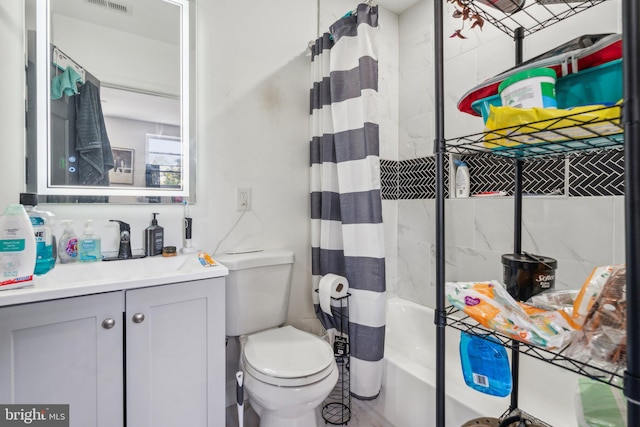 full bathroom featuring shower / tub combo, vanity, and toilet