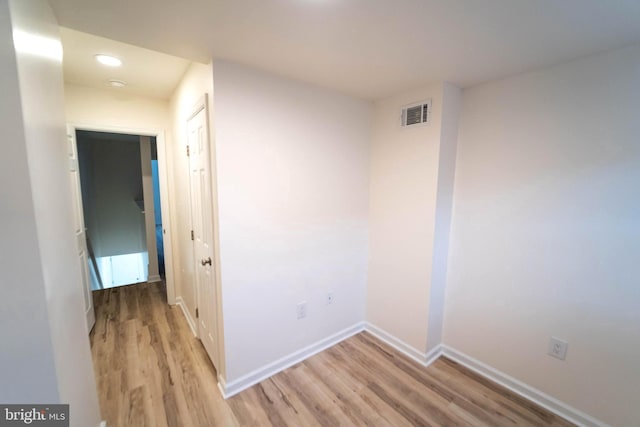 empty room with light hardwood / wood-style flooring