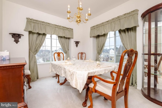 carpeted dining room featuring an inviting chandelier