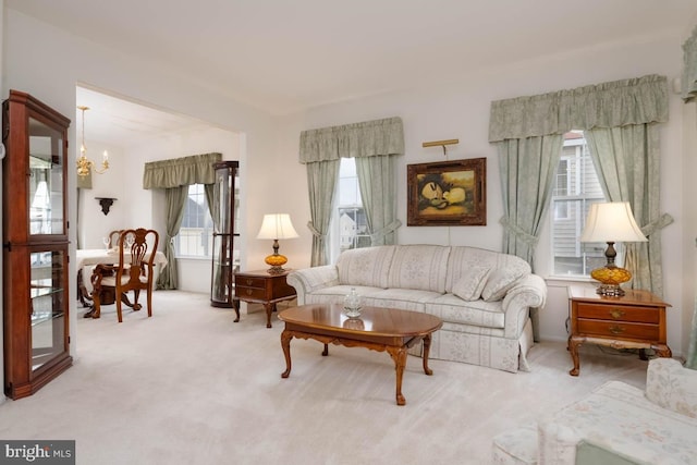 sitting room with an inviting chandelier and light colored carpet