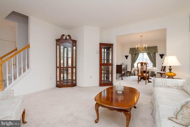 carpeted living room with a notable chandelier