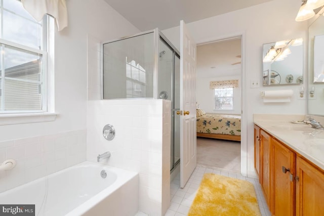 bathroom featuring tile patterned flooring, plus walk in shower, and vanity