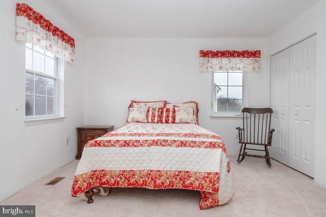 carpeted bedroom with a closet