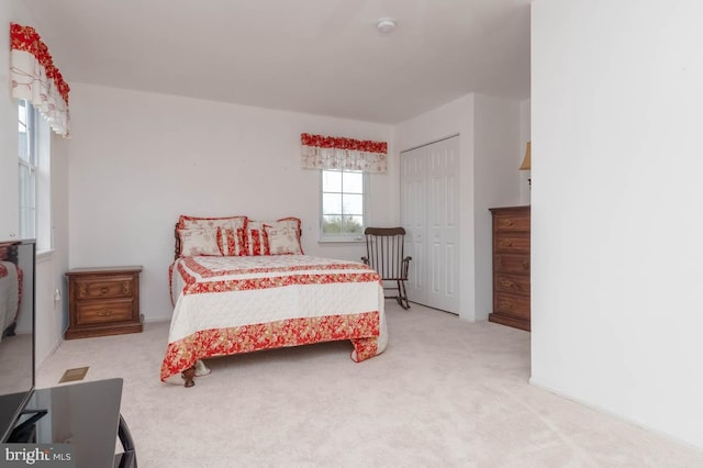 carpeted bedroom with a closet