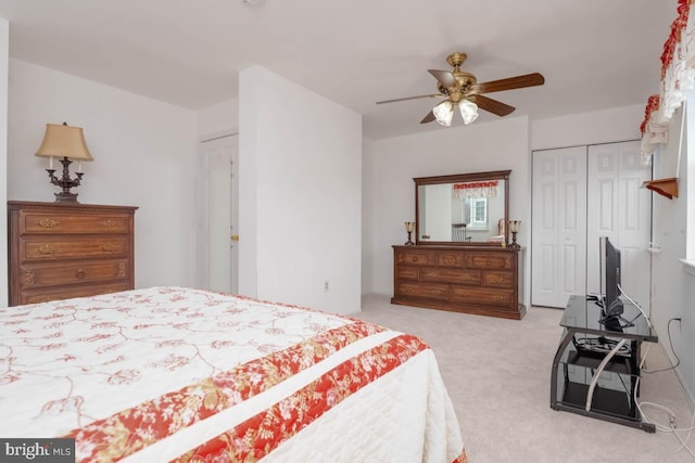 bedroom featuring ceiling fan, a closet, and light carpet