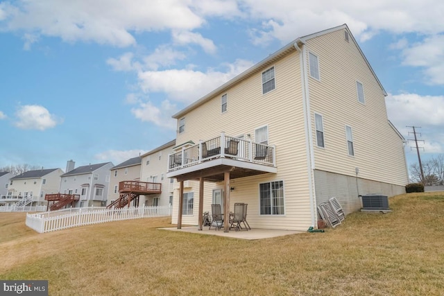 rear view of property with a wooden deck, central AC, a patio area, and a lawn