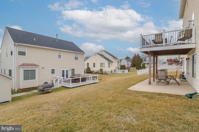 view of yard with a wooden deck and a patio