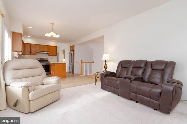 living room featuring light colored carpet and a chandelier