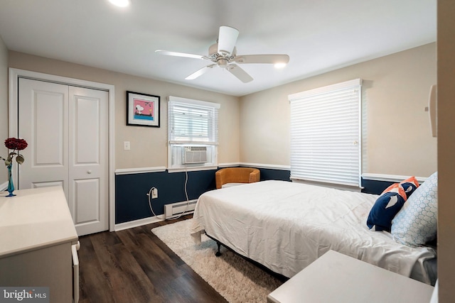 bedroom with a baseboard radiator, a closet, ceiling fan, and dark hardwood / wood-style flooring