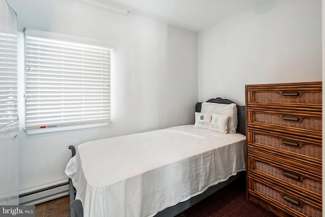 bedroom with a baseboard radiator and dark tile patterned flooring