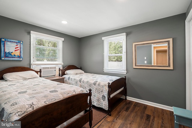 bedroom featuring cooling unit, multiple windows, and dark hardwood / wood-style floors