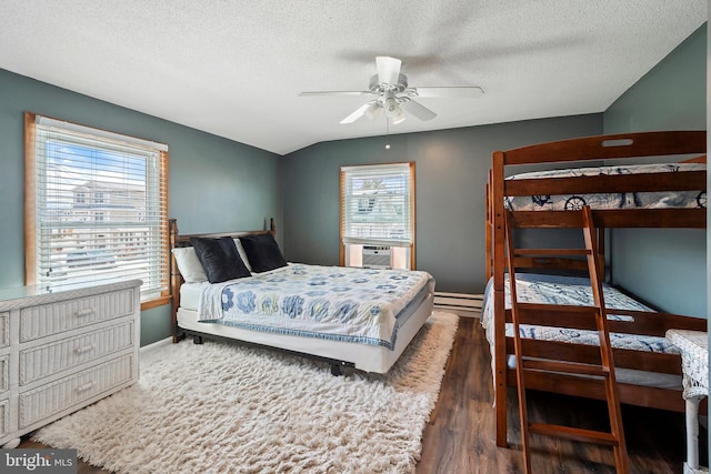 bedroom featuring ceiling fan, multiple windows, dark wood-type flooring, and a textured ceiling