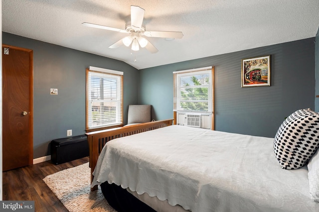 bedroom with ceiling fan, lofted ceiling, dark hardwood / wood-style floors, and multiple windows