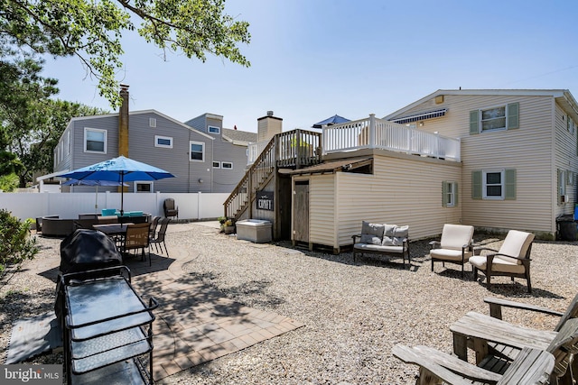 back of house featuring an outdoor hangout area, a patio area, and a deck