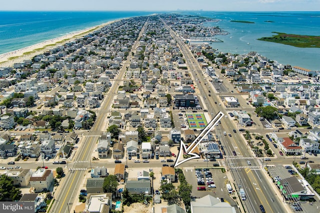 drone / aerial view with a water view and a view of the beach