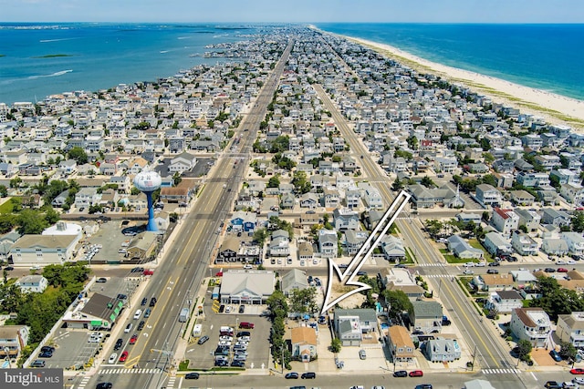 drone / aerial view featuring a view of the beach and a water view