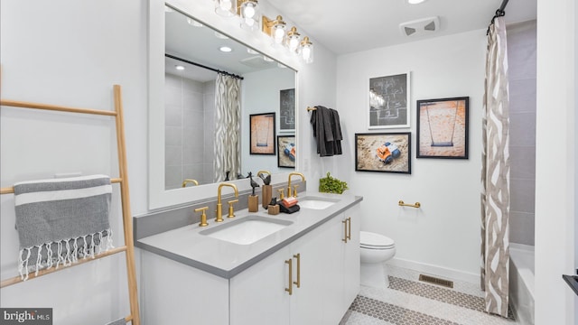 full bathroom with shower / tub combo with curtain, vanity, toilet, and tile patterned floors