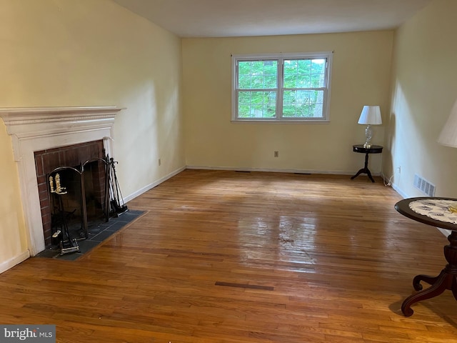 unfurnished living room with a fireplace and hardwood / wood-style floors