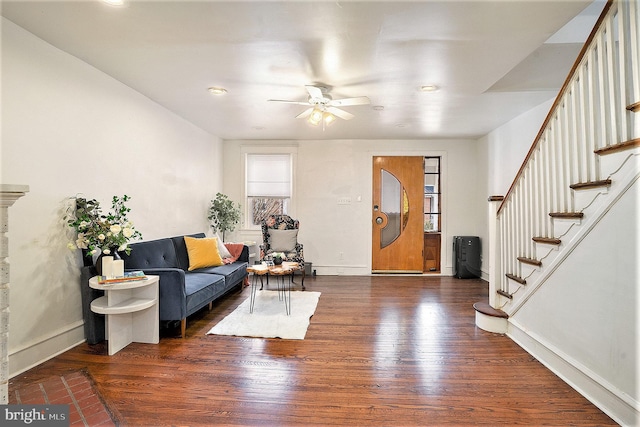 living room featuring ceiling fan and dark hardwood / wood-style flooring