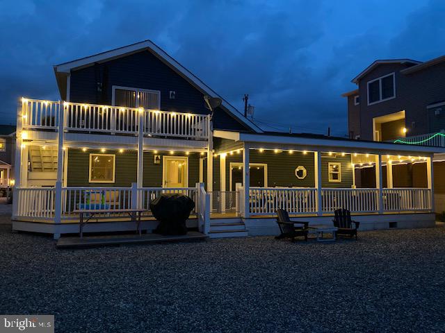 back of house featuring a balcony