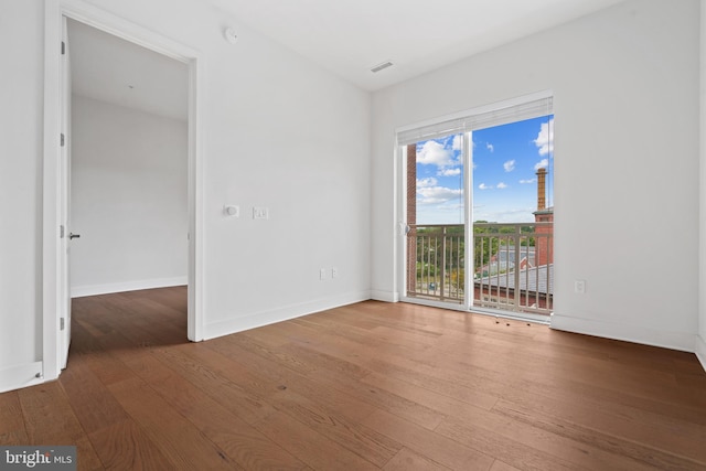 spare room featuring hardwood / wood-style flooring