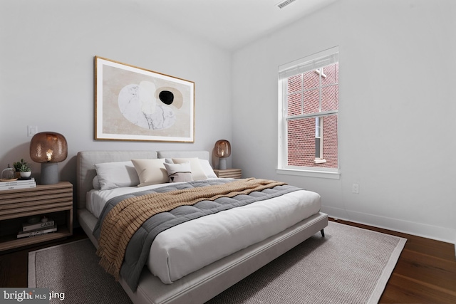 bedroom with dark hardwood / wood-style floors