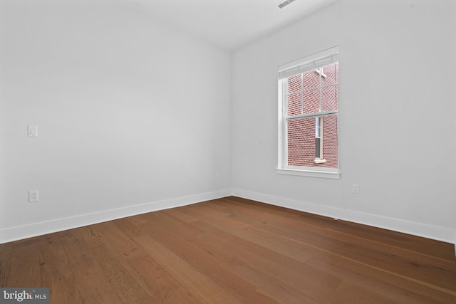 unfurnished room featuring hardwood / wood-style flooring