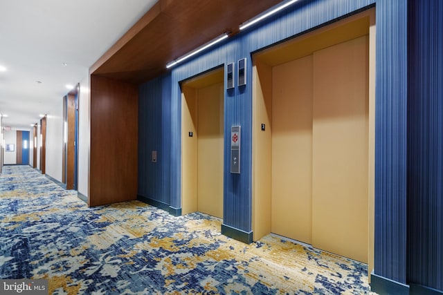 corridor featuring carpet floors and elevator