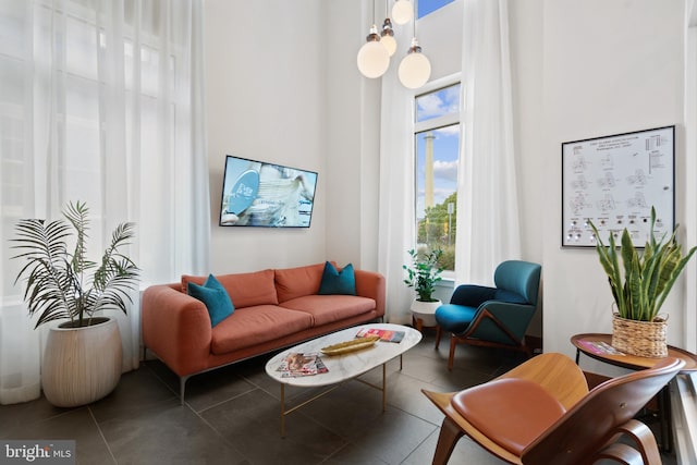 sitting room featuring dark tile patterned floors