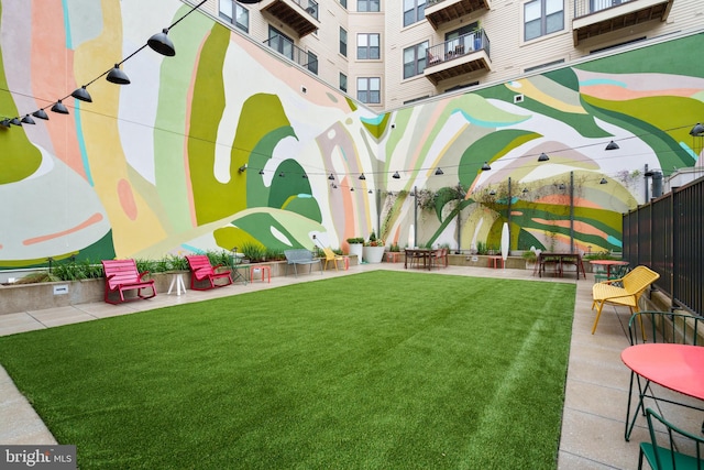 view of yard with a balcony and a patio