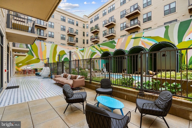 view of patio / terrace with a balcony and outdoor lounge area