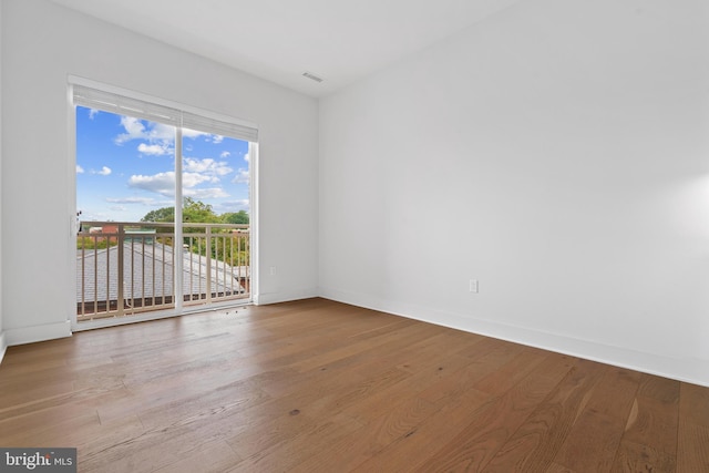 unfurnished room with hardwood / wood-style flooring