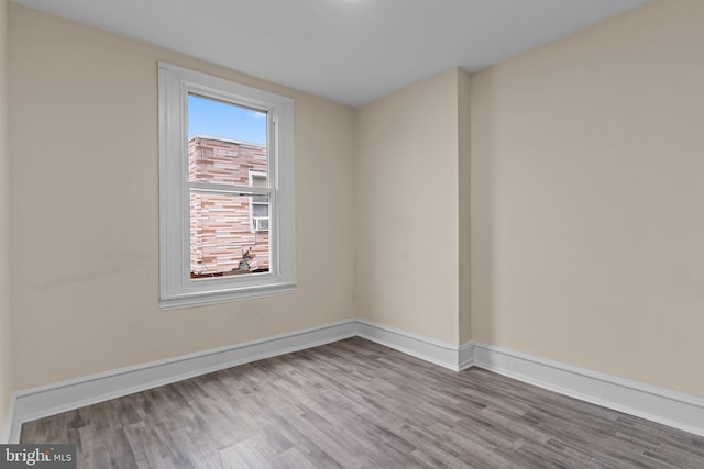 empty room with light hardwood / wood-style flooring