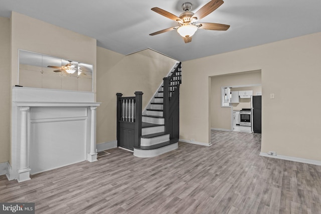 unfurnished living room with ceiling fan and light hardwood / wood-style flooring