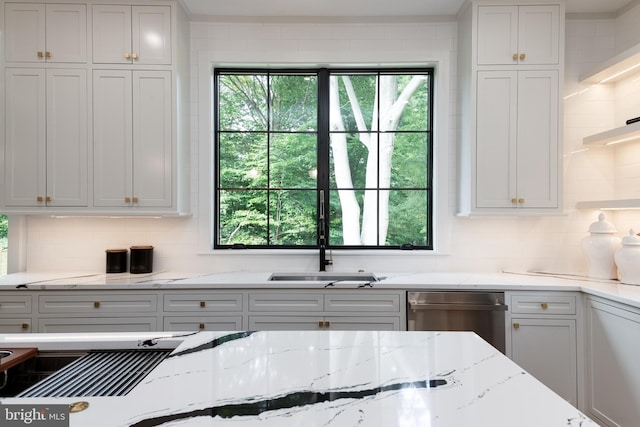 kitchen with light stone countertops, tasteful backsplash, and white cabinetry