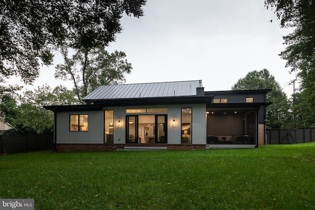 rear view of house with a lawn