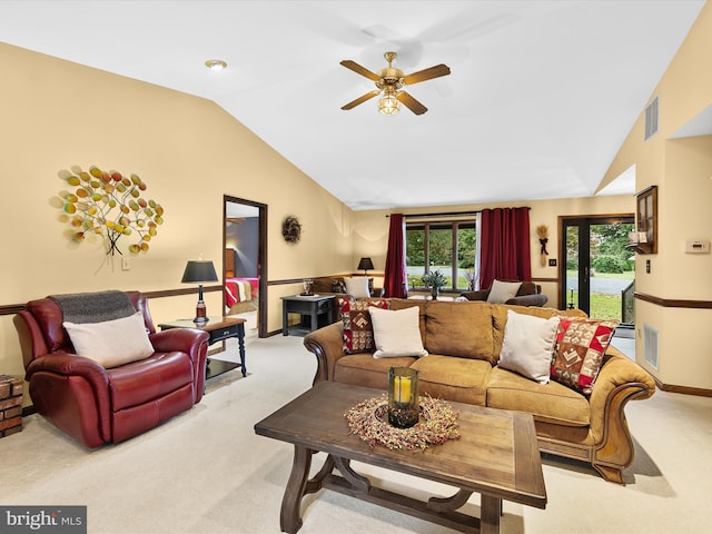 living room featuring vaulted ceiling, ceiling fan, and light colored carpet