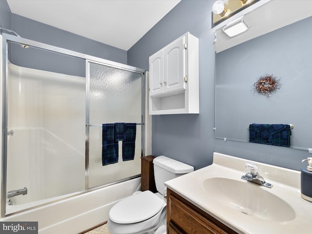 full bathroom featuring enclosed tub / shower combo, vanity, and toilet